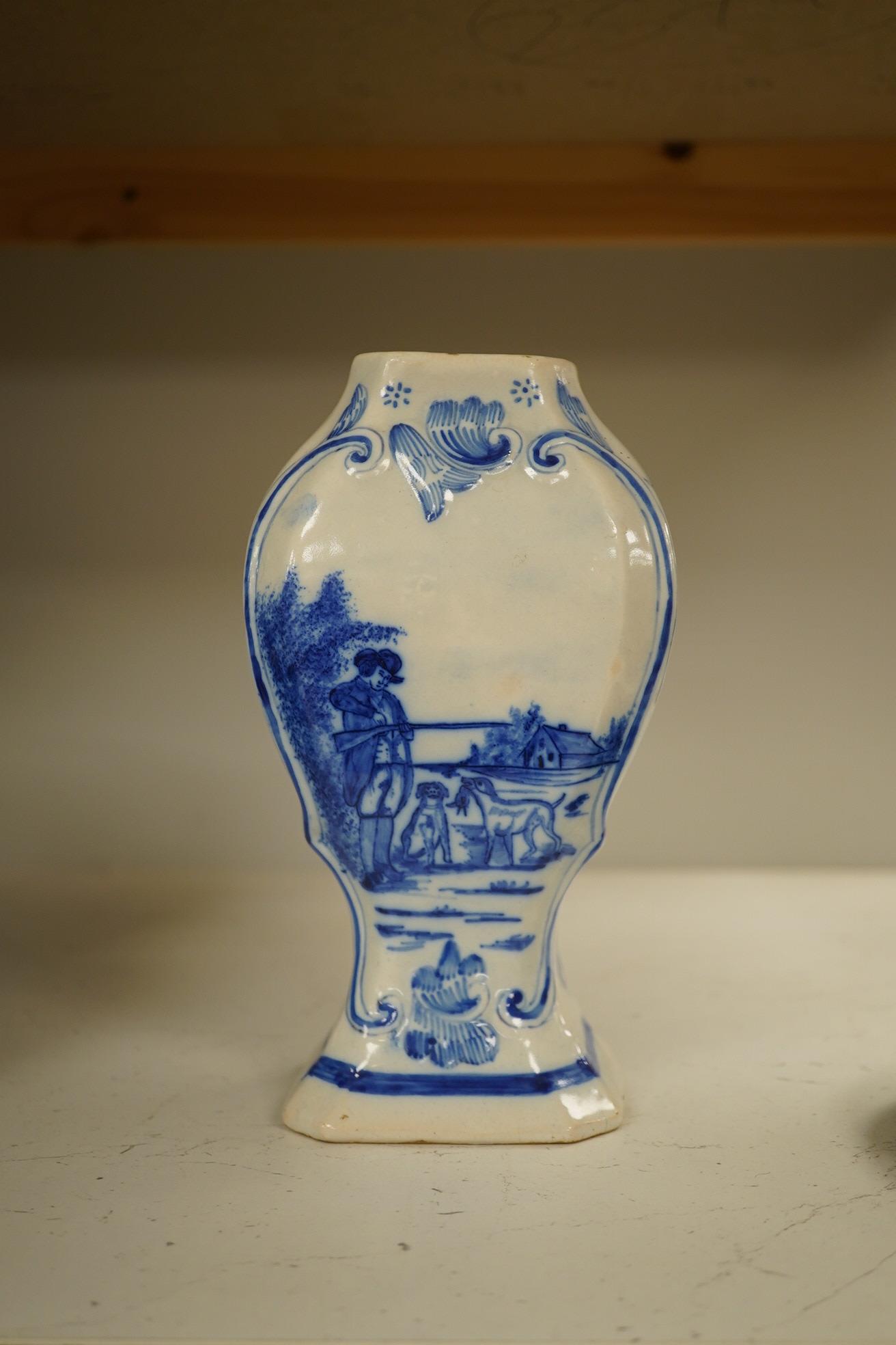 A 19th century Delft blue and white vase and a Watcombe Torquay pottery chamberstick, 19.5cm. Condition - both fair